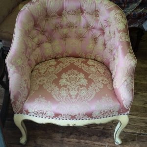 Reupholstered pink and white tufted back chair