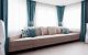modern couch with pillows matching turquoise draperies