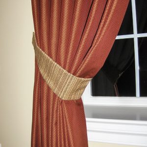 Pinch Pleated Drapery Panel pulled back with tapered tie back