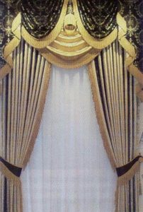 Contrast swag valance over sheers with side panels tied back.