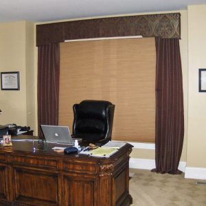 Honeycomb shade, shaped cornice, puddled drapes