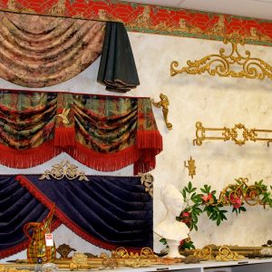 N J Rose Decorating showroom display showing swag valance with contrasting bell jabots – Kingston valance with bullion fringe and a turban valance with tassel fringe and various decorative hardware curtain rods and brackets.