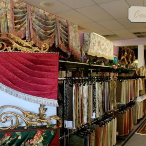 N J Rose Designer showroom display showing Pagoda style cornice, Austrian style swag and jabot, Turban valance and below that a Wrapped swag in contrast fabrics. Also shown are hundreds of fabric hanger samples to choose from for window treatments and upholstery.