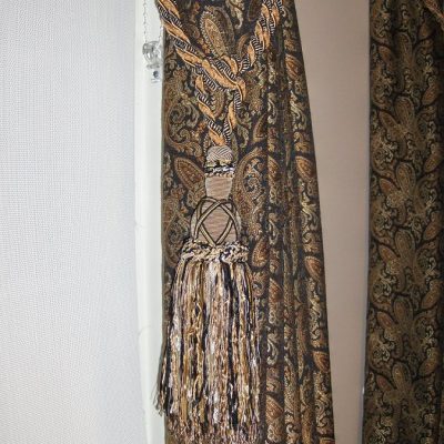 Draperies with large tassel tie back 