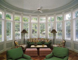 Garden room with single panel plantation shutters w/ tilt bars.