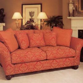 Brocade covered sofa and contrast pillows.