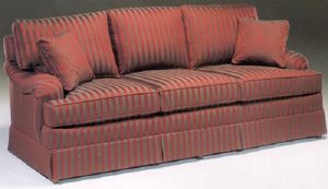 Traditional three seat sofa with skirt and accent pillows.