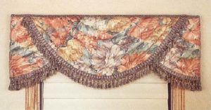 Wrapped swag valance with tassel fringe.