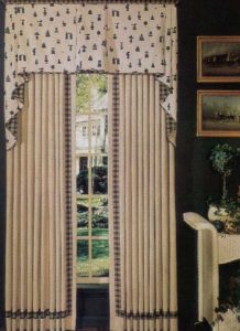 Box pleat valance in contrast fabrics over top of pinch pleated draperies.