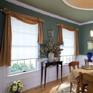 Cordless cellular honeycomb shade with scarf style swag valance over top.