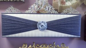 Straight cornice using three coordinating fabrics in fan fold design with a center Rosette.
