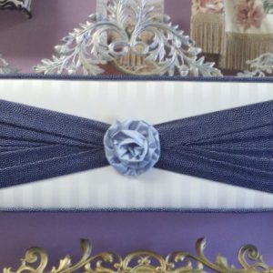 Straight cornice using three coordinating fabrics in a fan fold design with a center Rosette.