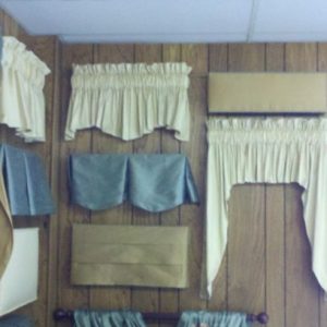 Display of various styles of valances, including rod pocket valances and others.